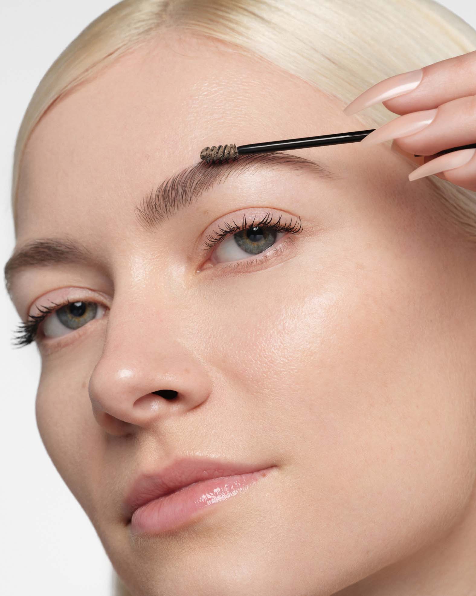 Applying Shade Taupe: Volumizing Tinted Brow Gel