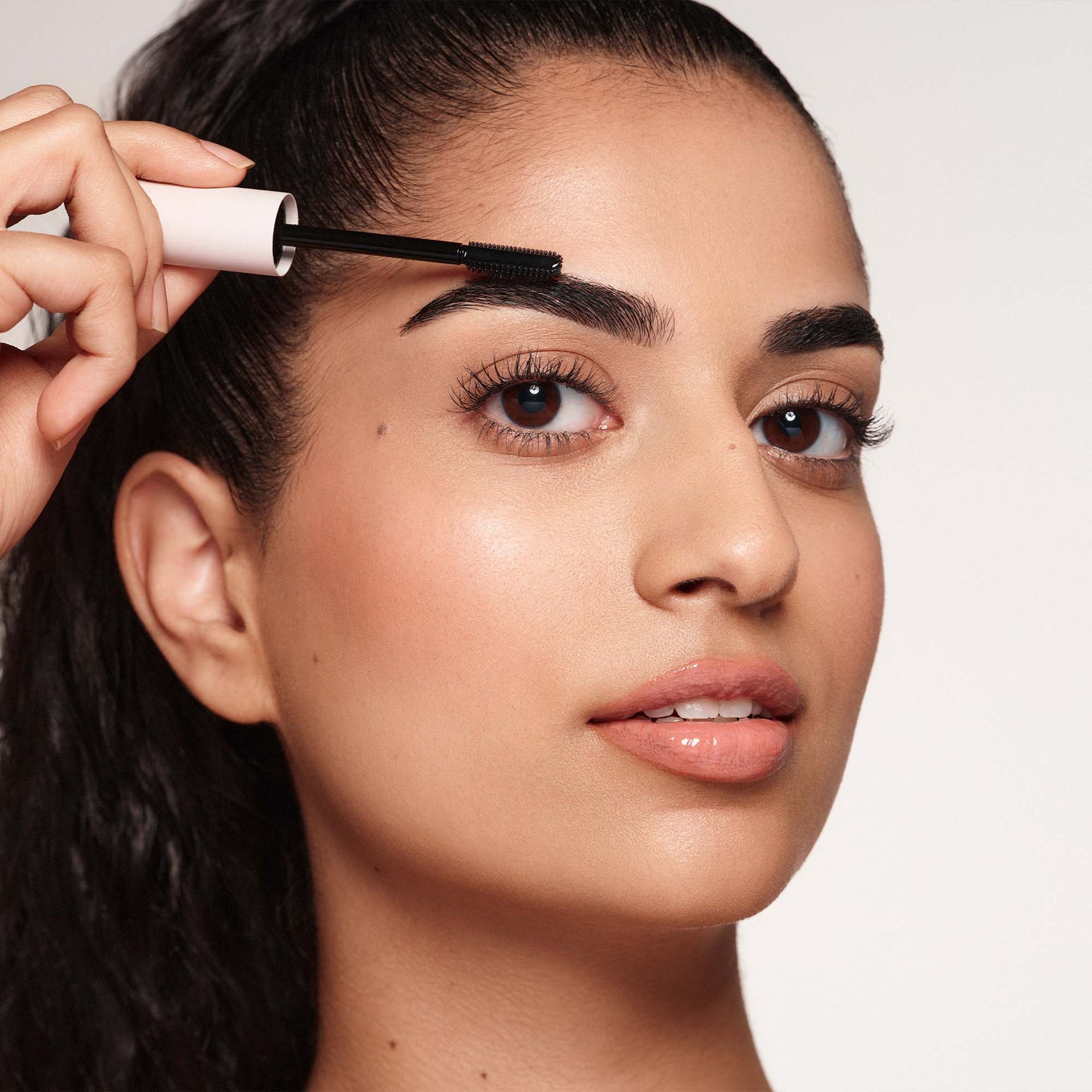 Sculpted Brow & Lash Duo - Model Holding Brow Freeze® Wand